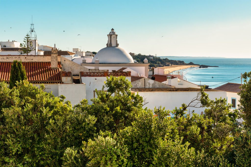 Algarve coastal lifestyle with traditional architecture and ocean views, one of Portugal’s top regions to live and invest