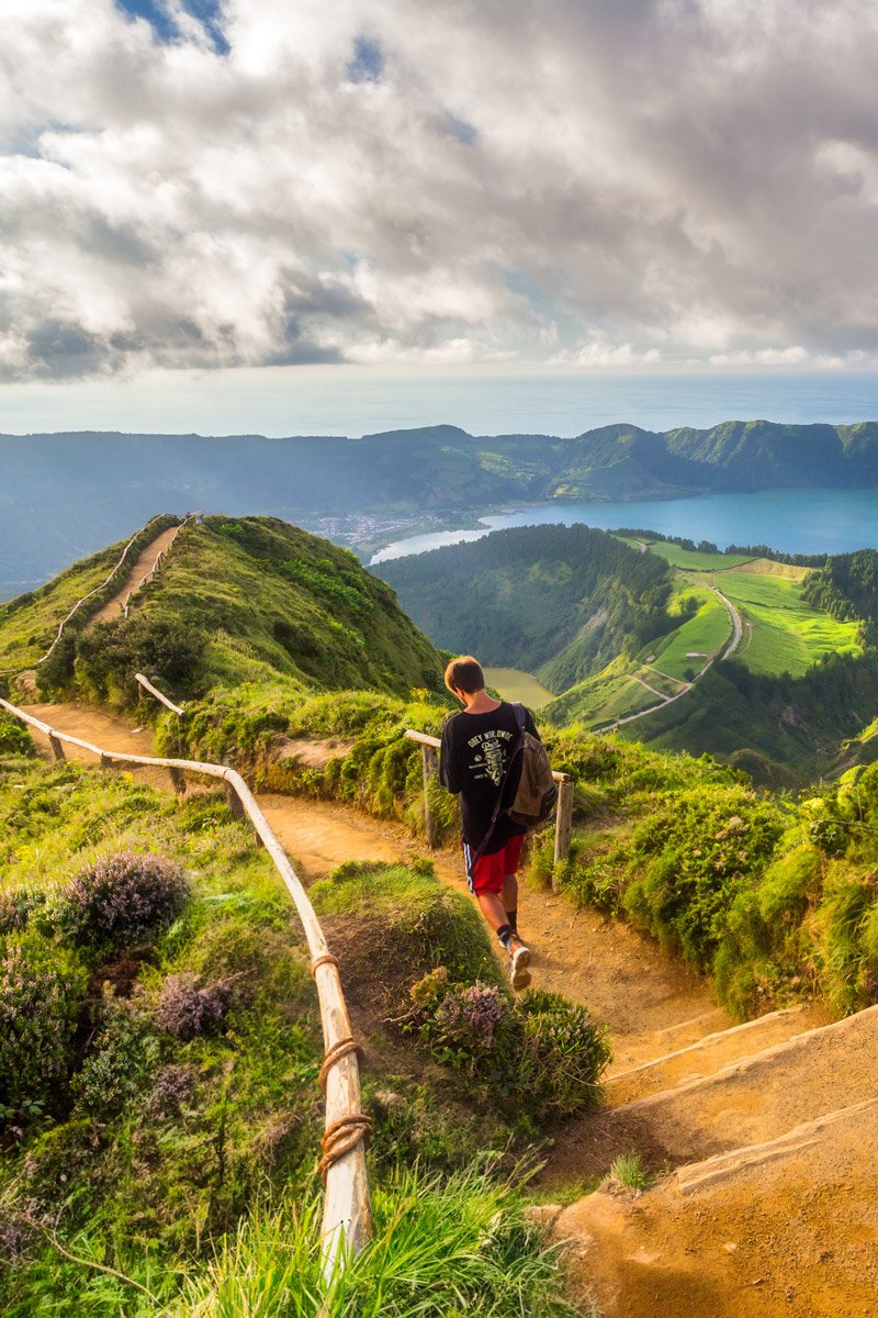 Hiker on the Sete Cidades ridge trail overlooking the lakes in São Miguel, Azores, Portugal