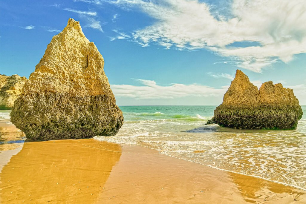 Praia dos Três Irmãos in Alvor (Portimão), Algarve, with golden sand, sea stacks, and turquoise Atlantic water