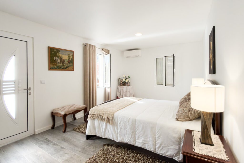 Master bedroom with direct access to the traditional village sidewalk in a Madeira country house.