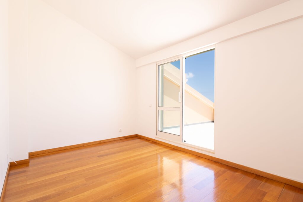 Bright empty sunroom or home office space with window access to terrace in Funchal apartment