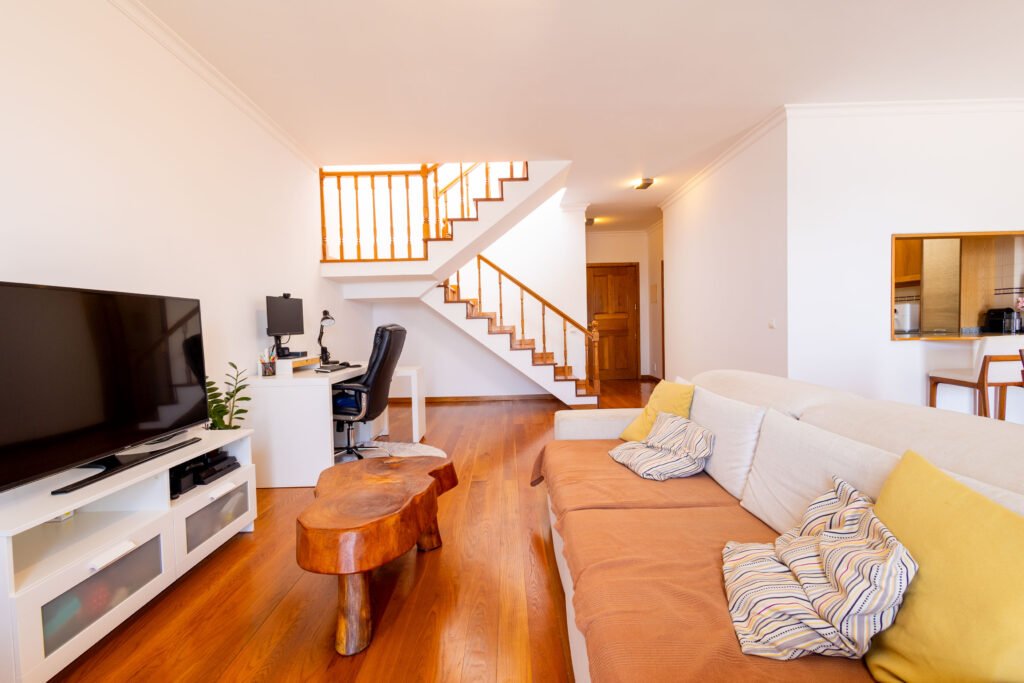 Modern living area with internal wooden staircase in T3 duplex apartment for sale in Sao Martinho Funchal