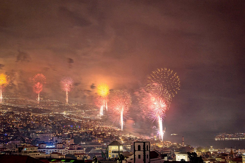 Panoramic view of Funchal Bay New Year's Eve fireworks display from apartment balcony in Sao Martinho Madeira